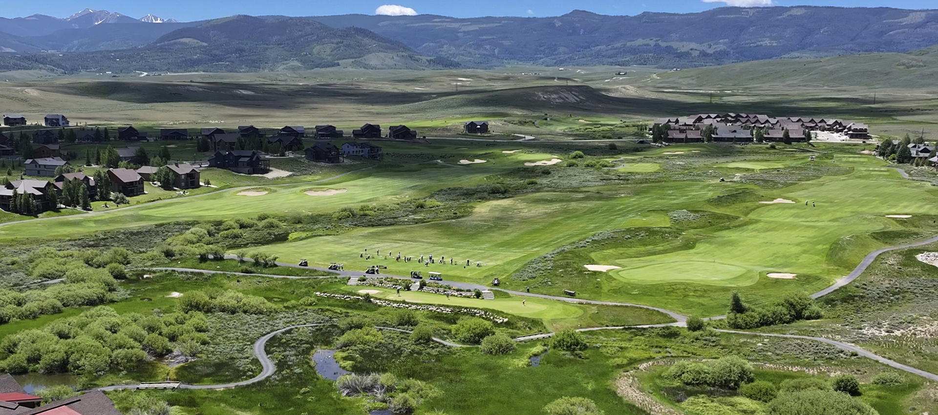 Grand Elk aerial view of the community including homes, multi-family units, golf, driving range and mountains in background