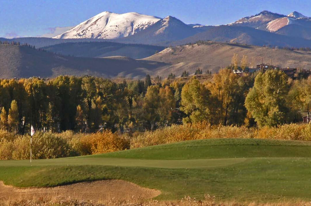 Grand Elk, fall photo with turning leaves and snow in background